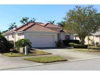 Charming one-story home with a tile roof, well-maintained landscaping, and a two-car garage at 3097 Royal Palm Dr, North Port, FL 34288