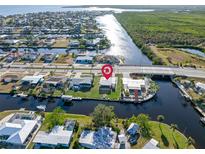 Aerial view of canal-front home with large backyard and patio at 21062 Edgewater Dr, Port Charlotte, FL 33952