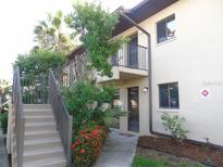 Condo building exterior with stairs, landscaping, and parking at 4048 Oakview Dr # F2-3, Punta Gorda, FL 33980