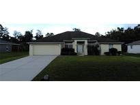 Charming single-story home with a two-car garage and landscaped front yard at 4692 Hillman Ter, North Port, FL 34288