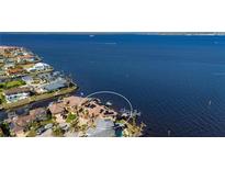 Stunning aerial view of a waterfront home with a private dock and solar panels at 2102 Palm Tree Dr, Punta Gorda, FL 33950