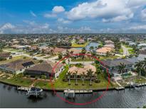 Waterfront home with private dock and lush green lawn at 3310 Tripoli Blvd, Punta Gorda, FL 33950