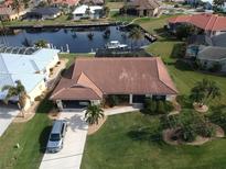 Stunning waterfront home with tile roof, lush landscaping, and boat access to the canal at 3448 Nighthawk Ct, Punta Gorda, FL 33950