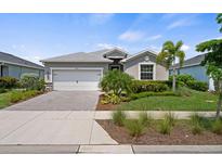 Single-story home with a two-car garage and landscaped yard at 43356 Waymark Pl, Punta Gorda, FL 33982