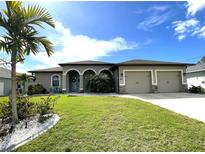 Beautiful two-story home with a three-car garage and lush landscaping at 283 White Marsh Ln, Rotonda West, FL 33947