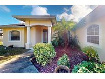 House exterior featuring a covered entryway, landscaping, and a large garage at 158 Eppinger Dr, Port Charlotte, FL 33953