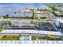 Aerial view of waterfront condo building with pool and parking at 150 Harborside Ave # 313, Punta Gorda, FL 33950