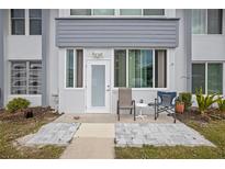 Exterior view of condo building showcasing a private patio and entrance at 21287 Gertrude Ave # 111, Port Charlotte, FL 33952