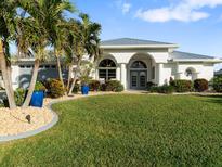 Lush landscaping surrounds the home at 4286 Albacore Cir, Port Charlotte, FL 33948