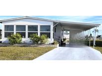 Charming single-story home with covered parking and well-maintained landscaping at 525 Parkwood Ave, North Port, FL 34287