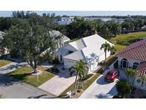 Aerial view of a single-story home with a tile roof and a two-car garage at 10208 Arrowhead Dr, Punta Gorda, FL 33955