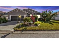 Attractive single-story home with well-manicured lawn and landscaping at 24088 Buckingham Way, Punta Gorda, FL 33980