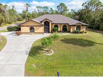 Single-story home with a large yard and driveway at 1160 Rizzo St, Port Charlotte, FL 33952