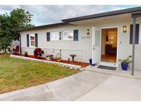 Charming single-story home showcasing well-kept landscaping and an inviting front entrance with a new paint job at 22143 Lasalle Rd, Port Charlotte, FL 33952