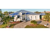 Beautiful single-Gathering home boasts a three-car garage and attractive landscaping at 2750 W Marion Ave, Punta Gorda, FL 33950