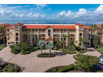 Resort-style building with waterfront views and palm trees at 87 Vivante Blvd # 8736, Punta Gorda, FL 33950