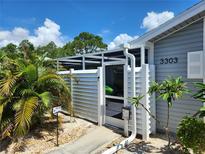 Charming home featuring a secure and private screened-in entry, offering both security and inviting curb appeal at 3300 Loveland Blvd # 3303, Punta Gorda, FL 33980