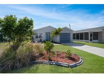 Charming single-story home with a well-manicured lawn and tasteful landscaping, offering great curb appeal at 20037 Sancraft Ave, Port Charlotte, FL 33954