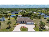Stunning single-Gathering home with circular driveway, lush landscaping and screened-in lanai at 4122 Library St, Port Charlotte, FL 33948