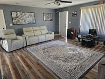 Living room with hardwood floors, a comfortable white couch, and decorative art on the walls at 1174 Victoria Ave, Port Charlotte, FL 33948