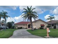 Charming single-story home with a well-manicured lawn and a unique seahorse-shaped mailbox at 674 Monaco Dr, Punta Gorda, FL 33950