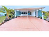This covered carport boasts ample parking and a charming entrance to the home at 6642 Acacia Ct, North Port, FL 34287