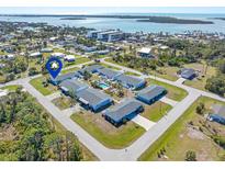 Aerial view of charming condos with a community pool and stunning ocean views in a desirable neighborhood at 1956 Wyoming Ave, Englewood, FL 34224