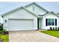 Charming single-story home featuring a paved driveway, two-car garage, and well-maintained landscaping at 9525 Turtle Grass Cir, Punta Gorda, FL 33950