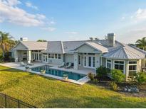 Stunning home featuring a private pool, patio with fireplace, and lush landscaping at 27320 Egret Pl, Punta Gorda, FL 33983
