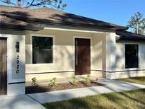Charming new home featuring modern front door with a welcoming covered entry at 2920 Barry Rd, North Port, FL 34286