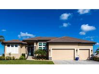 Beautiful home featuring a three-car garage, manicured landscaping, and a neutral color palette at 17122 Barcrest Ln, Punta Gorda, FL 33955