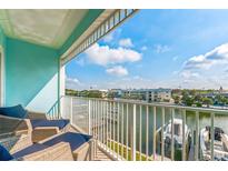 Balcony offers picturesque views of the canal and community, enhanced with comfortable seating for relaxation and enjoyment at 11723 1St E St, Treasure Island, FL 33706