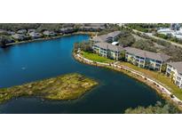 Beautiful aerial view of the condo community, featuring a scenic lake and well-maintained landscaping at 19335 Water Oak Dr # 202, Port Charlotte, FL 33948