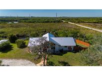 Aerial view of the house situated in a large lot with well-maintained landscaping at 29175 River Dr, Punta Gorda, FL 33982