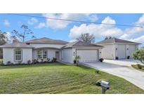 Charming single-story home with well-maintained lawn and a convenient two-car garage and an additional detached garage at 3080 Belleville Ter, North Port, FL 34286