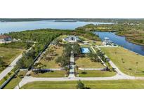 Expansive estate featuring lush grounds, a tennis court, and luxurious homes with waterfront access at 13000 Windcrest Dr, Port Charlotte, FL 33953