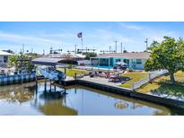 Enjoy waterfront living with a private boat dock, pool, and outdoor entertaining area at 21184 Edgewater Dr, Port Charlotte, FL 33952