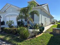 Charming single-story home with a well-manicured front yard featuring lush landscaping and a welcoming walkway at 24313 Westgate Blvd, Punta Gorda, FL 33980