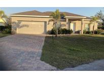 Charming single-story home featuring a two-car garage, brick paved driveway, and well-maintained landscaping at 244 Surinam St, Punta Gorda, FL 33983
