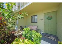 Charming condo front door with garden, seating area, and decorative wreath for a welcoming entrance at 25225 Rampart Blvd # 1604, Punta Gorda, FL 33983