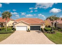 Beautiful home with a well-manicured lawn, tile roof, and large brick driveway, creating great curb appeal at 3748 Albacete Cir # 38, Punta Gorda, FL 33950