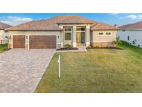 Stunning single-story home featuring a tile roof, paver driveway, and a two-car garage at 4320 Vasco St, Punta Gorda, FL 33950
