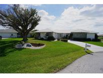 Beautiful one-story home with a stone accent wall, tidy landscaping, and a spacious green lawn at 1407 Waxwing Ct, Punta Gorda, FL 33950