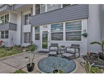 Inviting front porch with seating area, plants, and stylish decor for relaxing outdoor enjoyment at 21287 Gertrude Ave # 106, Port Charlotte, FL 33952