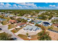 Wide aerial view of a light-colored single-story home showcasing a spacious lot and neighborhood at 21332 Walling Ct, Port Charlotte, FL 33954