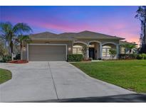 Charming one-story home boasts a well-manicured lawn and a welcoming two-car garage at 3946 Cinderella Rd, North Port, FL 34286