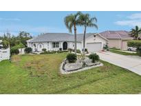 Beautiful single-story home with a two-car garage, ample driveway space, and meticulous landscaping at 5244 Early Ter, Port Charlotte, FL 33981