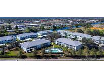 Enjoy the community pool and surrounding waterways in this beautiful aerial view of the complex at 5725 Greenwood Ave # 3104, North Port, FL 34287