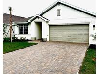 Charming single-Gathering home featuring an attached two-car garage and a beautifully brick-paved driveway at 9516 Turtle Grass Cir, Punta Gorda, FL 33950