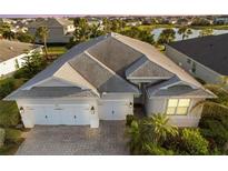 Stunning home featuring a three-car garage, brick paved driveway and lush landscaping in a well-maintained community at 17917 Wayside Bnd, Punta Gorda, FL 33982